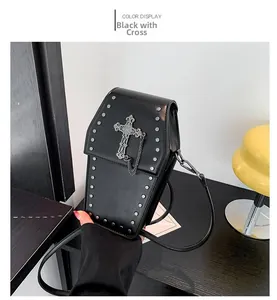 Detailed macro view of coffin-shaped gothic crossbody bag with silver studs and metal cross