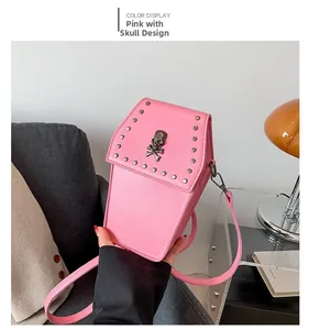 Detail of pink coffin shaped crossbody bag with silver skull ornament and metal studs