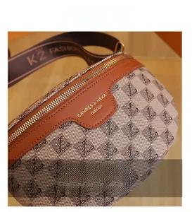 Detail of monogram canvas chest bag with gold zipper and wide jacquard shoulder strap