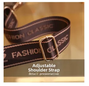 Detail of adjustable woven shoulder strap with gold metal buckle and fashion classic text