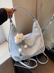 Light blue large capacity hobo backpack with silver butterfly accents and cloud charm