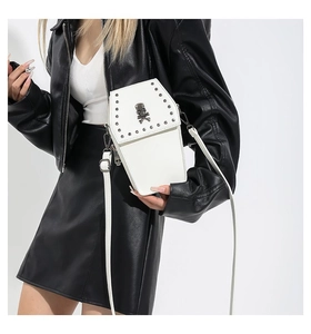 Gothic white coffin crossbody bag with metal rivets and skull emblem on model