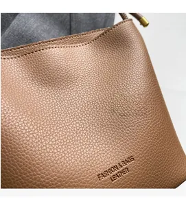 Close-up of caramel brown pebble leather with embossed Fashion & Bags text