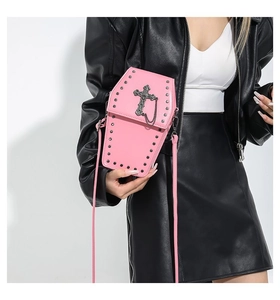 Detail view of pink coffin shaped gothic crossbody bag with cross and silver studs decoration