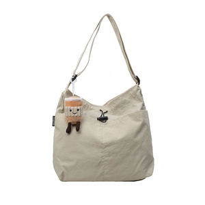 Versatile cream nylon tote bag with adjustable strap and cute coffee cup plush pendant