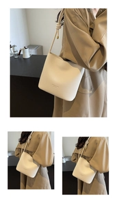 Detail of minimalist bucket bag showing lychee grain leather and fashion lettering