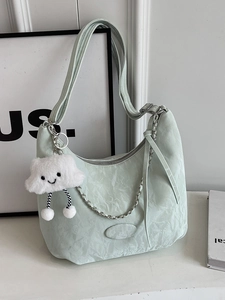 Chic mint green hobo bag with pleated texture, silver chain and plush cloud charm