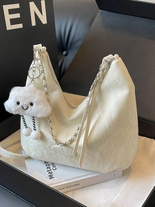 Chic off-white hobo bag with marble texture, silver chain strap and plush cloud charm