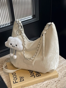 Chic cream-white textured hobo bag with silver chain and cloud plush charm decoration