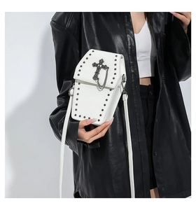 White coffin-shaped gothic crossbody bag with silver rivets and cross detail on model