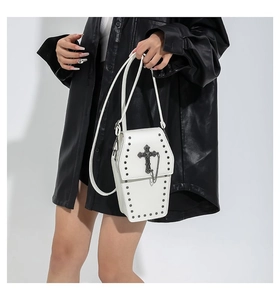 Gothic white coffin crossbody bag with vintage silver cross and rivet details on model
