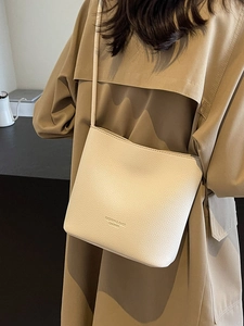 Fashionable creamy white textured leather bucket bag with elegant shoulder strap for women