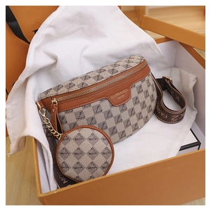 Detailed view of luxury monogram chest bag and small round pouch in an orange gift box