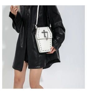 Gothic white coffin crossbody bag with dark silver cross and stud detailing on a model