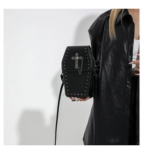 Detail of gothic coffin crossbody bag featuring silver rivets and vintage cross with chains