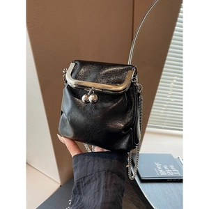 Elegant black leather mini bucket bag with silver chain strap and metallic clasp closure