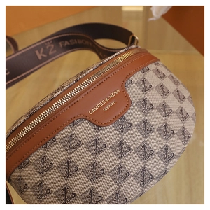 Detailed close-up of textured fabric and premium leather stitching on the chest bag