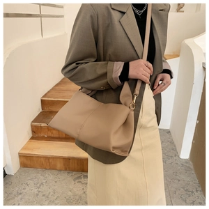 Detail of hobo shoulder bag in khaki leather with golden hardware and wide strap