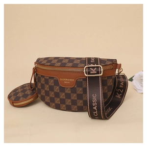 Macro detail of brown checkered chest bag with floral logo and gold zipper hardware