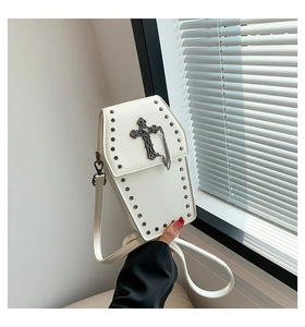 Close-up of white gothic coffin crossbody bag with cross and rivet details