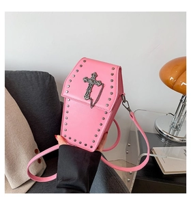 Pink gothic coffin-shaped crossbody bag featuring metal studs and a large relief cross detail