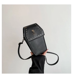 Detailed view of coffin-shaped gothic PU leather crossbody bag with skull and stud accents