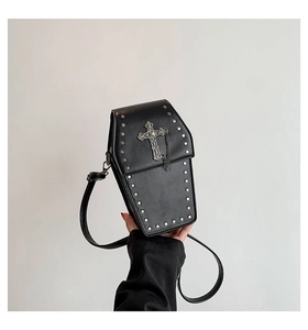 Detail of gothic coffin-shaped crossbody bag with silver cross and rivet embellishments