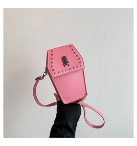 Pink coffin-shaped gothic crossbody bag featuring skull metal stud and rivet details