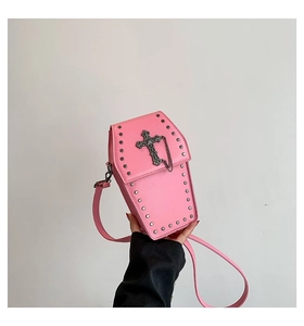 Detail of pink coffin-shaped crossbody bag with silver gothic cross and rivet accents