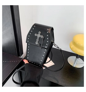 Detail of gothic coffin crossbody bag with silver cross, chains and metal rivets
