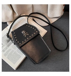 Detail of gothic punk crossbody phone bag with silver skull logo and metal rivets