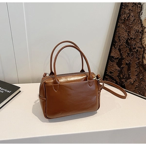 Vue détaillée du sac vintage en similicuir marron avec doubles poignées et fermeture éclair