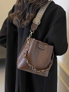 Retro dark brown leather bucket bag with woven handle and vintage patterned wide strap