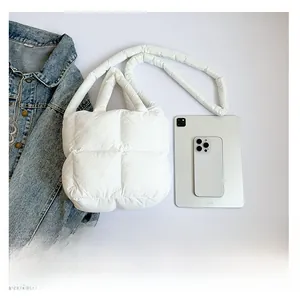 Détail du sac matelassé blanc montrant sa grande capacité avec une tablette de comparaison