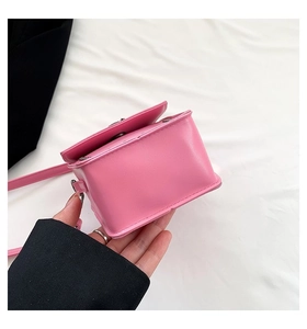 Detail view of pink crossbody bag showing neat stitching and bottom leather structure