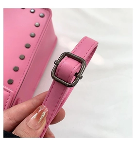 Detail view of the pink faux leather shoulder bag showing the dark gunmetal strap buckle