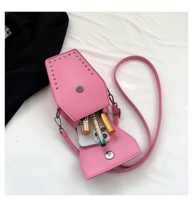 Pink coffin shaped crossbody bag with silver studs showing interior storage for smartphone
