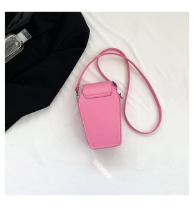 Pink coffin-shaped crossbody bag made of faux leather with gothic rivet details