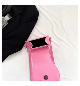 Pink rivet crossbody bag showing magnetic closure and interior space on white fabric