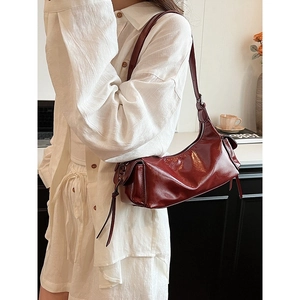 Retro dark red soft leather underarm bag for women with tassel details and zipper closure