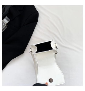 Top view of white faux leather mini bag showing magnetic closure and interior space