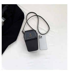 Detailed top view of gothic coffin cross-body bag with skull relief and silver studs