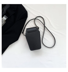 Close-up of gothic coffin-shaped crossbody bag in matte black leather with metal strap clips