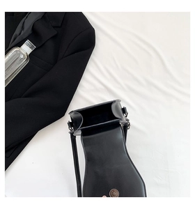 Internal view of black gothic rivet crossbody bag showing magnetic snap and lining