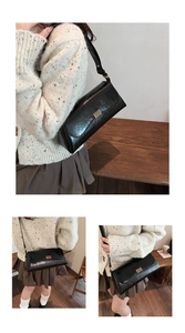 Close-up of black oil-wax texture leather bag featuring a gold rectangular buckle