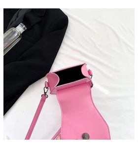 Pink rivet crossbody bag with black interior lining and magnetic closure detail