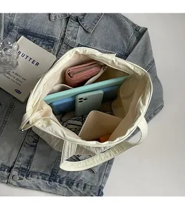 Top view of large capacity white pleated tote bag showing interior storage and accessories