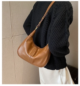 Brown leather hobo bag worn by a model to show the size and vintage texture