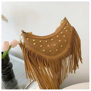 Détail du sac bohème en daim marron avec de longues franges et des rivets dorés
