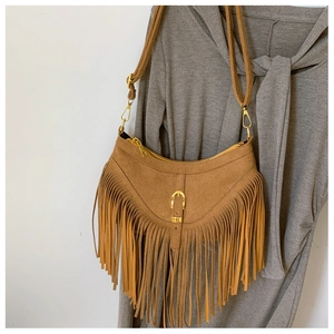 Détail du sac bohème en daim marron avec de longues franges et une forme de demi-lune